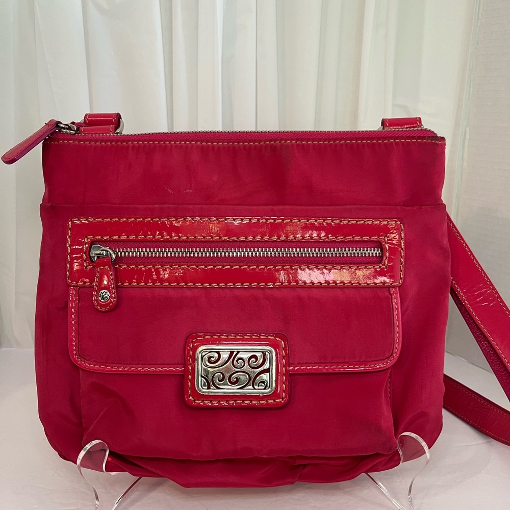 Brighton Fuschia Crossbody Bag with Front Pocket and Decorative Emblem